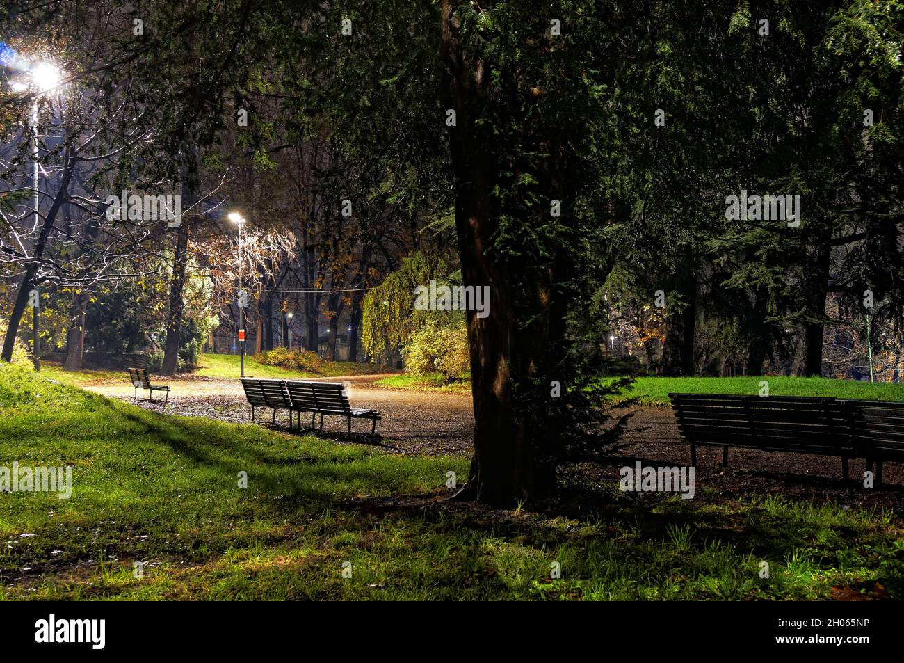 Night Walking in a dark silent deserted public park on a muddy path after the rainfall - Indro Montanelli Gardens - Milan - Italy Stock Photo