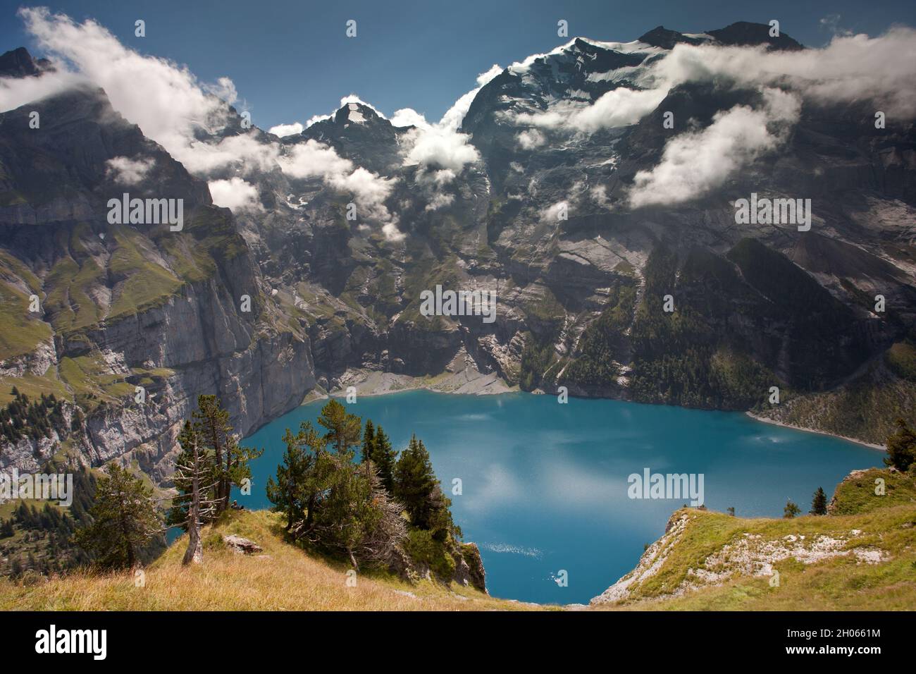 Oeschinen Lake with Larches and Doldenhorn Stock Photo