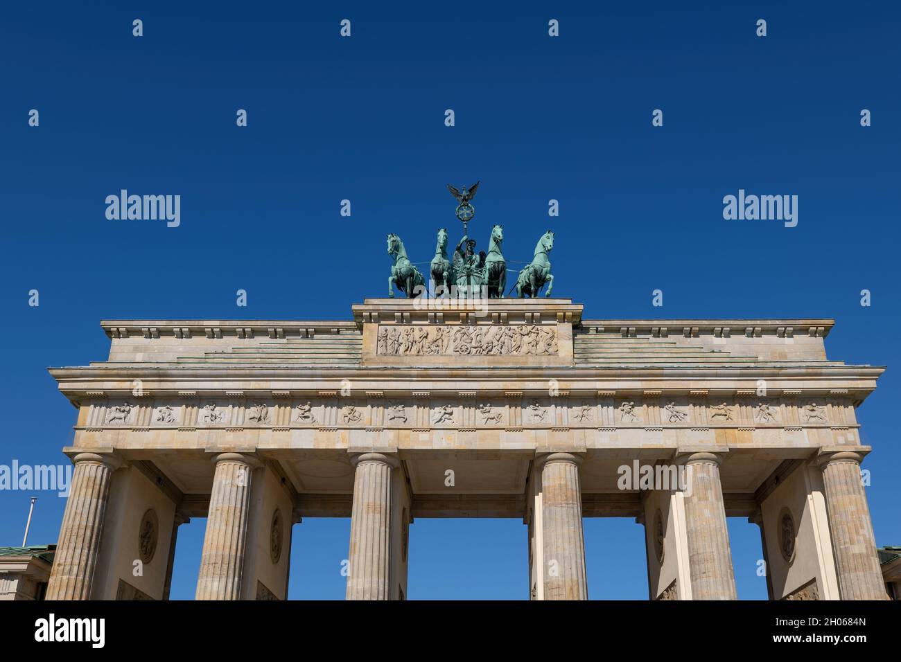 Top of the Brandenburg Gate against blue sky in city of Berlin, Germany. Stock Photo