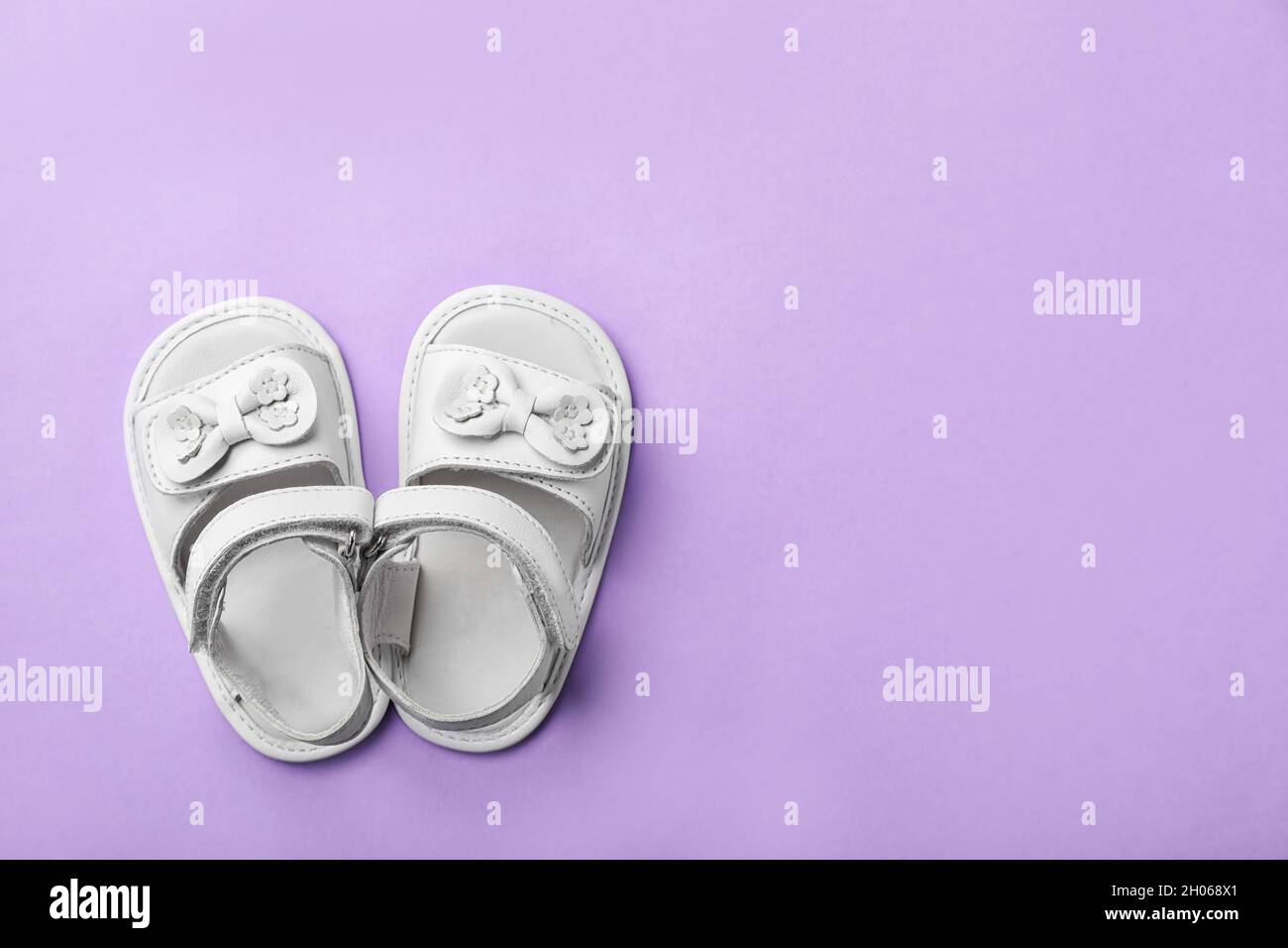 Pair of cute baby sandals on color background, top view Stock Photo - Alamy
