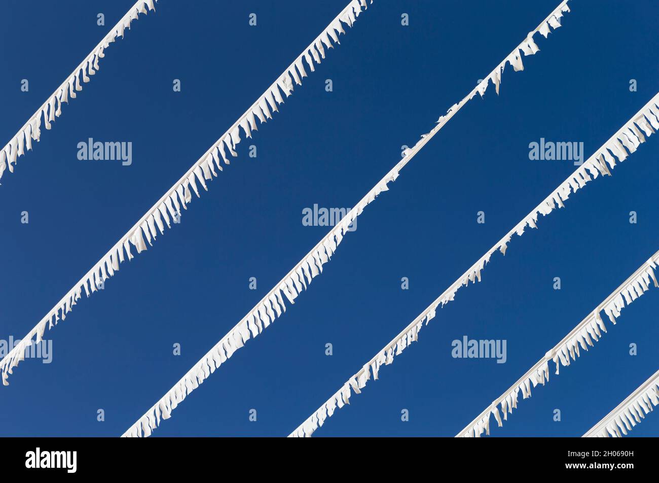 The photo shows white paper garlands with blue sky in Mallorca Stock Photo