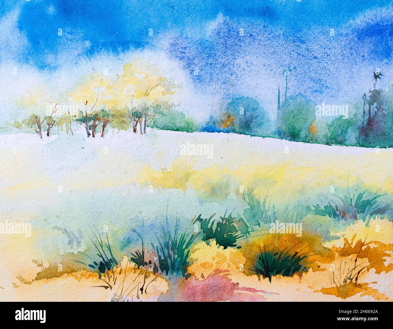Indian landscape watercolor painting with distant trees of a field and blue sky in background. Stock Photo