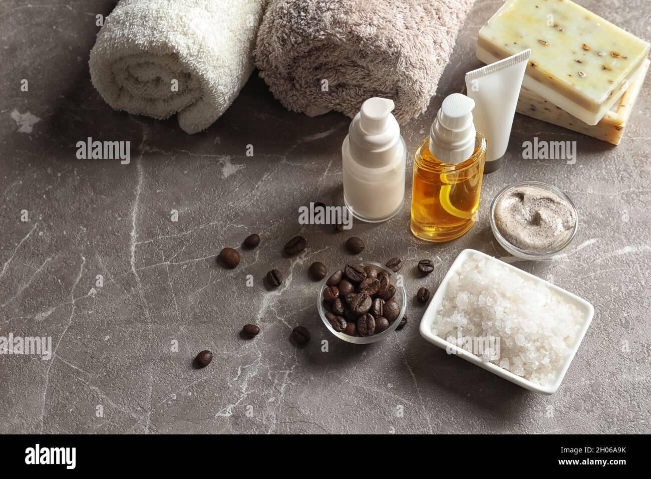 Handmade natural body scrub, ingredients and cosmetic products on table