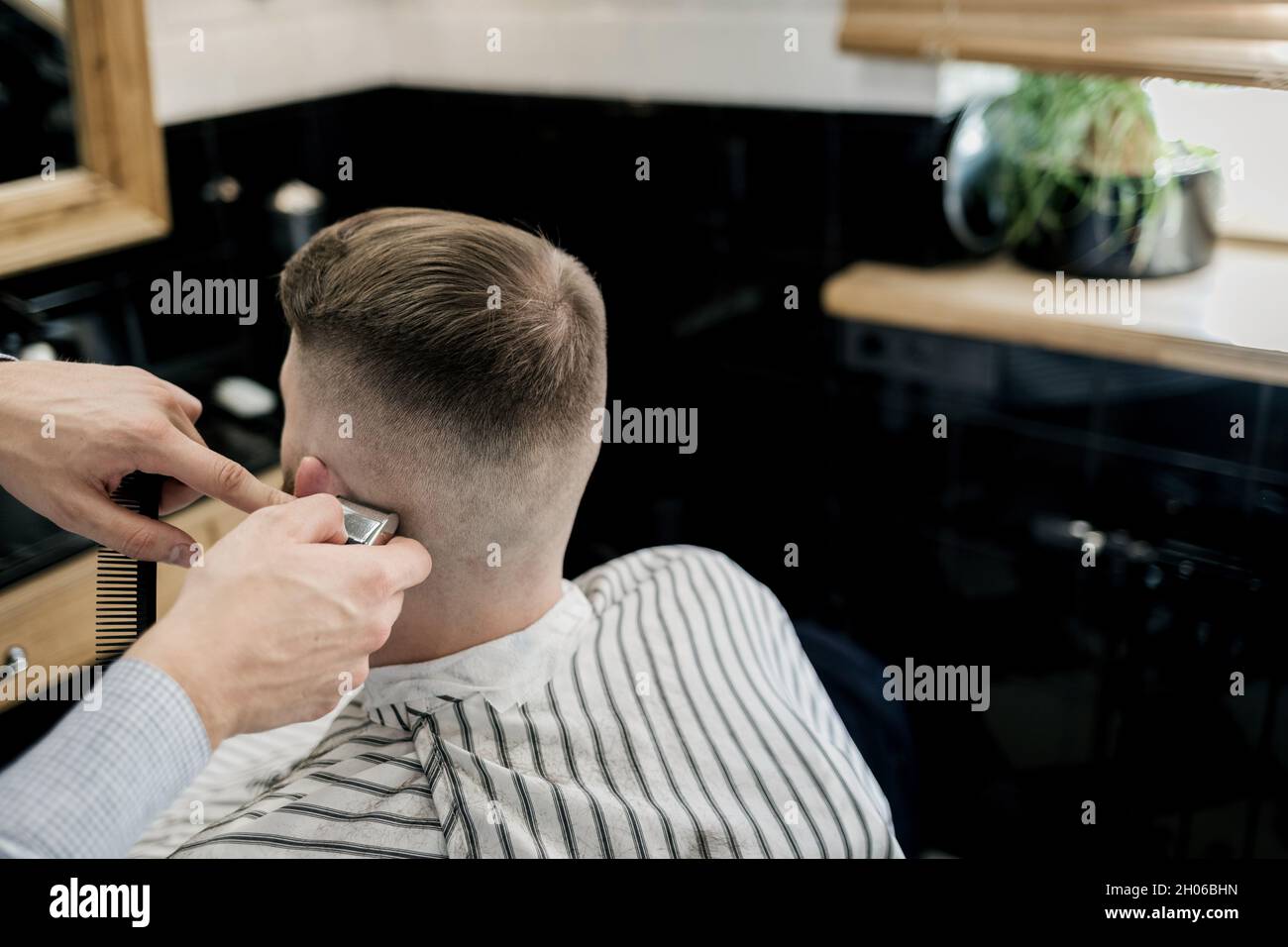 Premium Photo  Haircut men barbershop. men's hairdressers barbers. barber  cuts the client machine for haircuts.