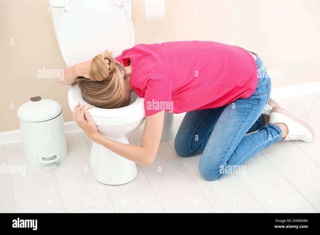 Young woman vomiting in toilet bowl at home Stock Photo Alamy
