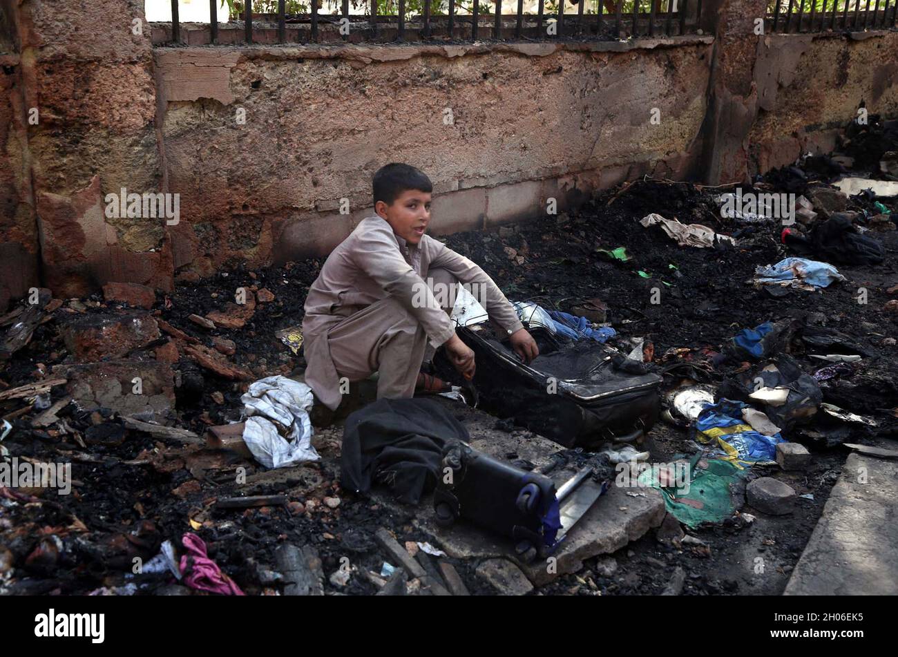 View of venue after fire broke out incident at Chawla Market located on Nazimabad area of Karachi on Monday, October 11, 2021. Several shops, pushcarts and stalls were gutted in a fire that broke out in Chavla Market in Nazimabad No 1 area of Karachi on Sunday night causing losses of up to millions of rupees. However, no casualties were reported. Stock Photo