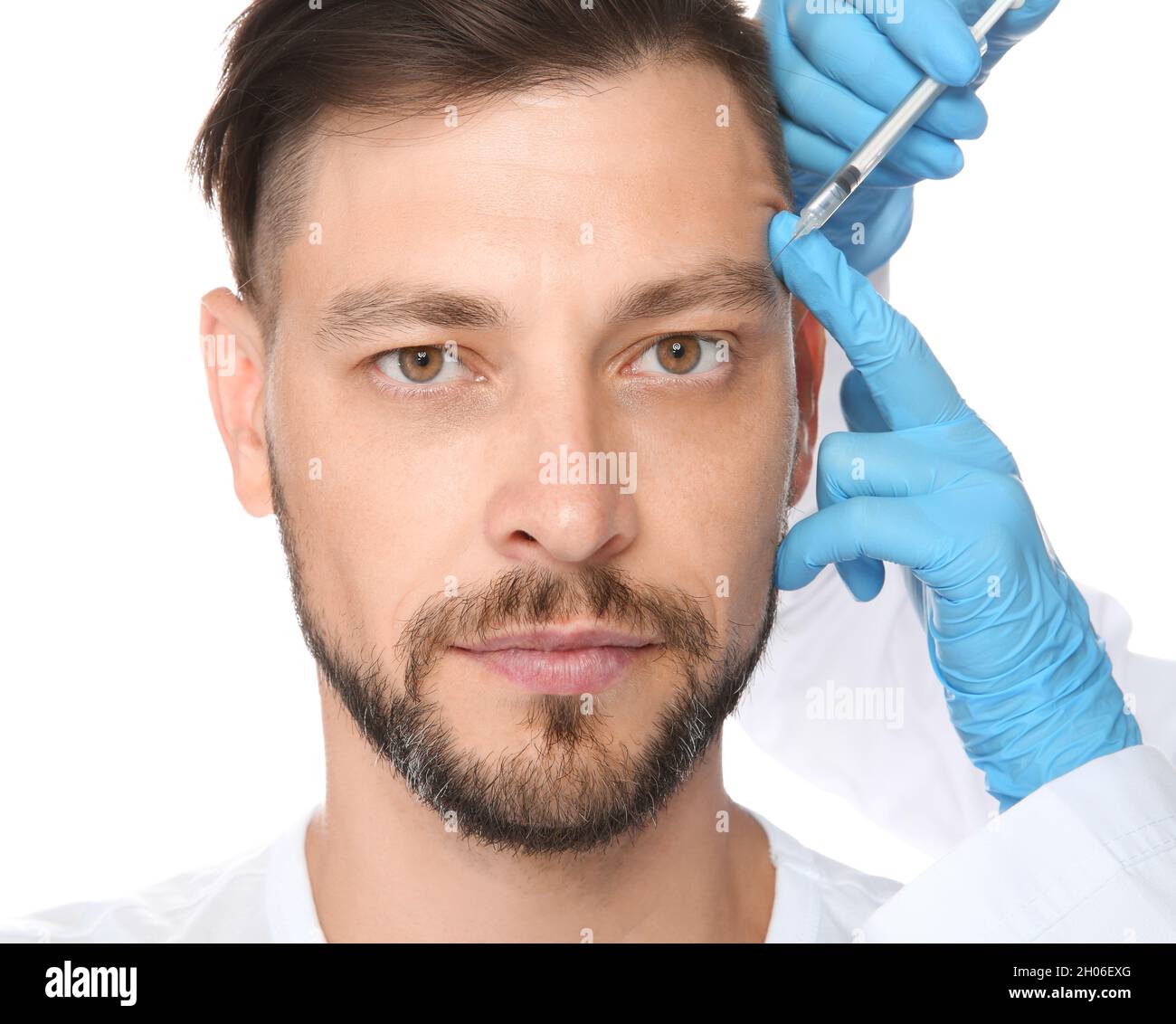 Mature man getting facial injection on white background. Cosmetic