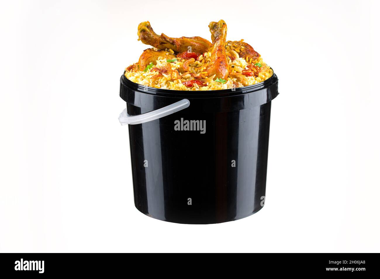 Chicken Bucket Biryani, Kerala dum chicken biryani arranged in a black bucket container with white textured background. Stock Photo