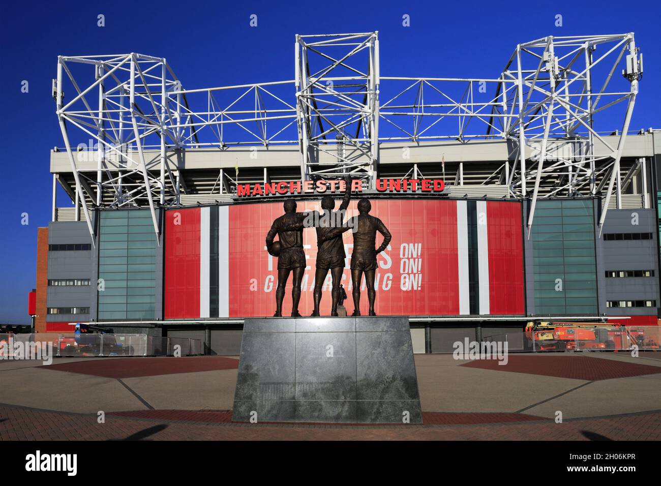 The United Trinity sculptor by Philip Jackson, Manchester United's Old Trafford ground, Manchester, England, UK Stock Photo