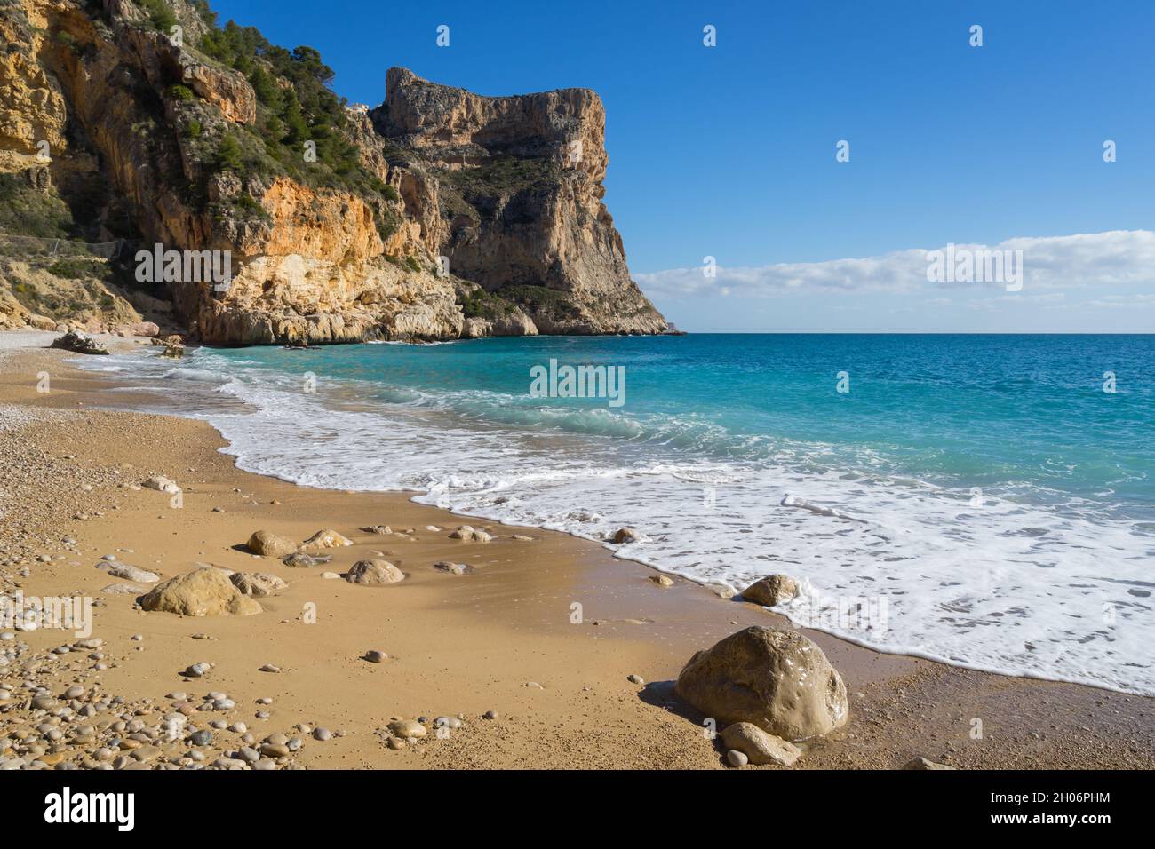 Mediterranean beach clear blue water cliffs and fine sand in Spain beautiful travel destination Cala Moraig on the Costa Blanca Stock Photo