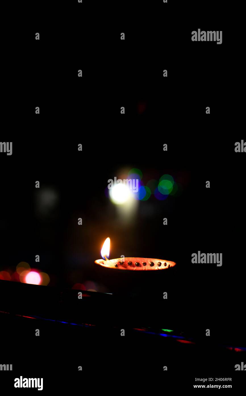 Diwali diya with background bokeh light during night time. This