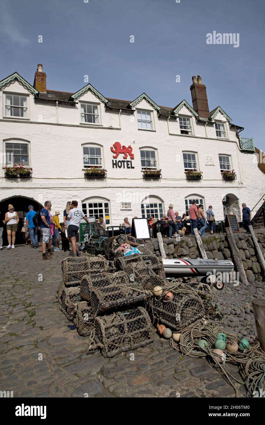 Red Lion Hotel overlooking Clovelly harbour with boats moored on the beach at low tide North Devon Stock Photo