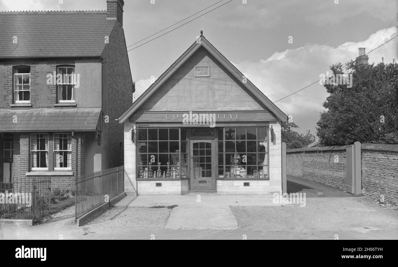 1950s, exterior of a local Co-Operative shop, Wheatley, Oxford, England, UK, built in 1913 and owned by the Oxford Co-Operative and Industrial Society Ltd. The British Co-Operative movement, known as the Co-Op, started with the Rochdale Society of Equitable Pioneers in 1844, a commerical enterprise run for the benefit of its members, who would receive a dividend from profits. Around 300 individual Co-Operatives in the North of England become the Co-Operative Wholesale Society (CWS), an organisation supplying their members own stores with products made in their society's factories. Stock Photo