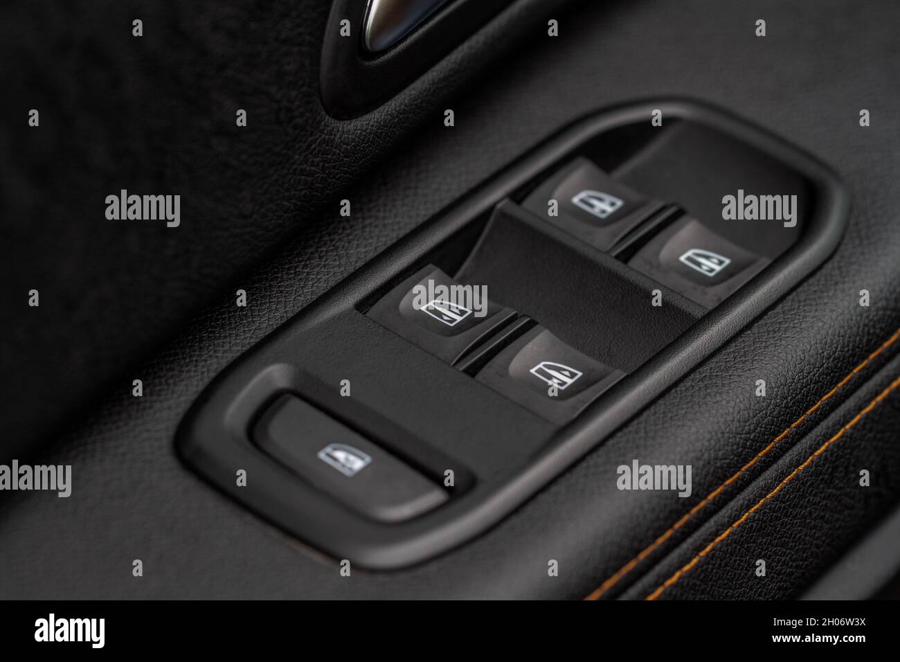 Close up view of button controlling window in modern car interior