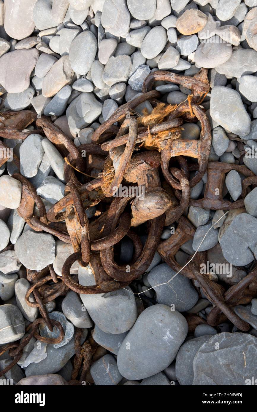 Rusty chain on bebble beach Clovelly North Devon Stock Photo