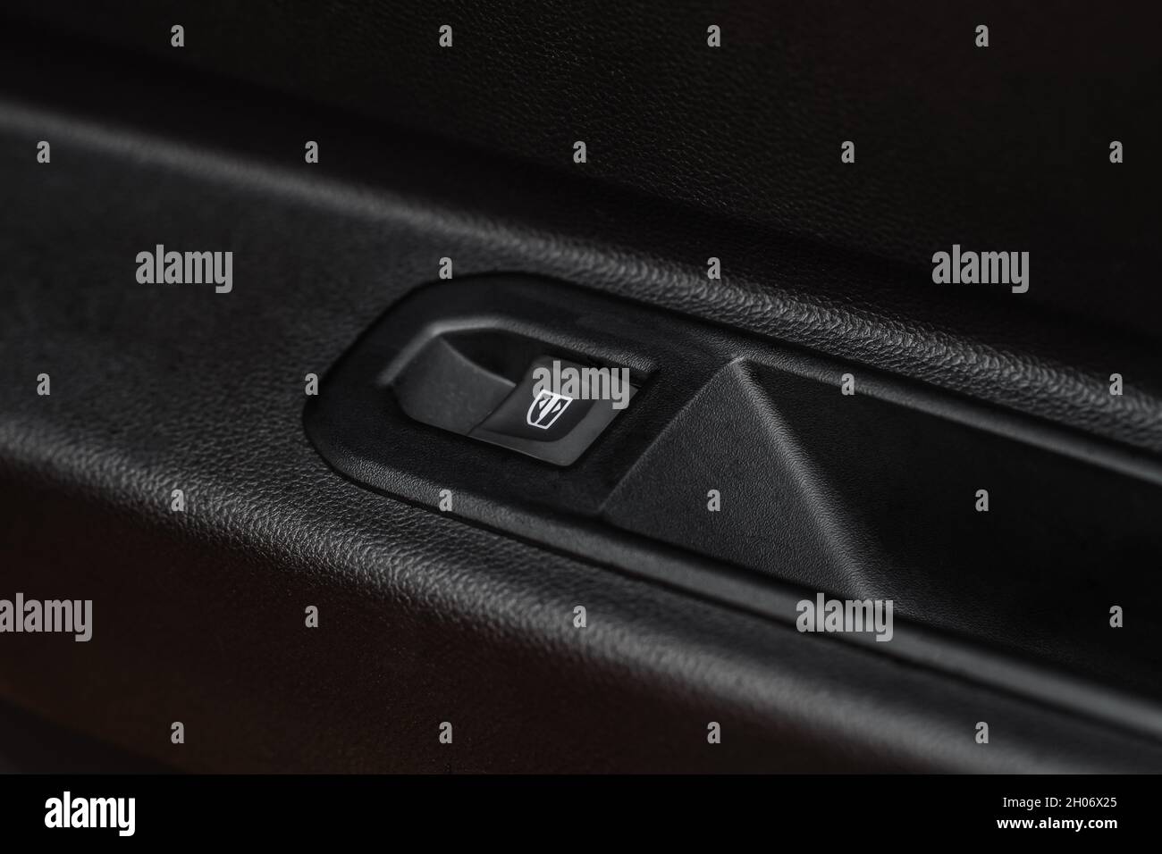 Close up view of button controlling window in modern car interior