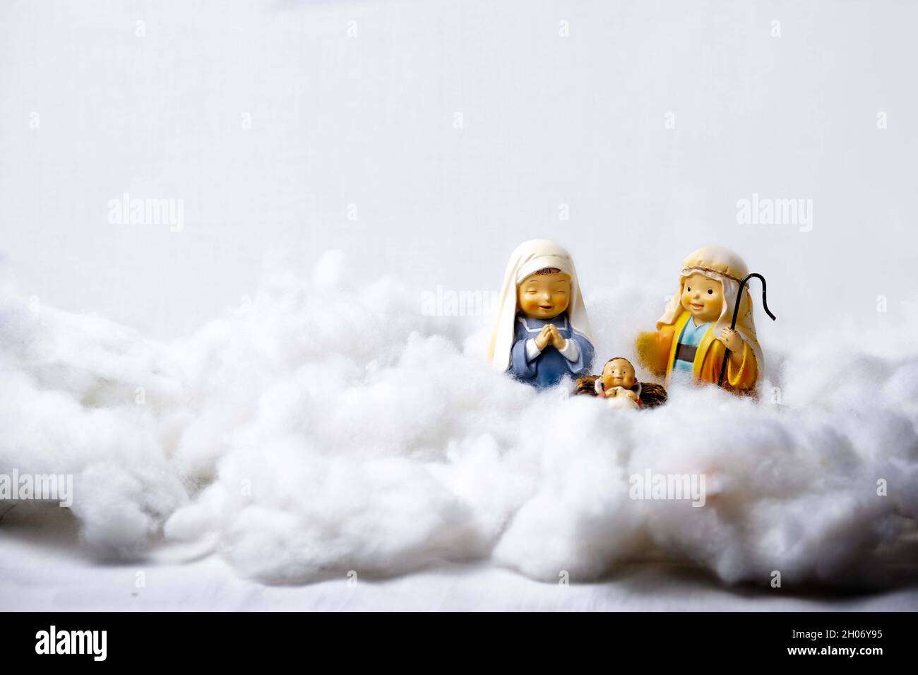 Figures of Portal de Belén on cotton simulating clouds. Christmas greeting concept. Copy Space Stock Photo