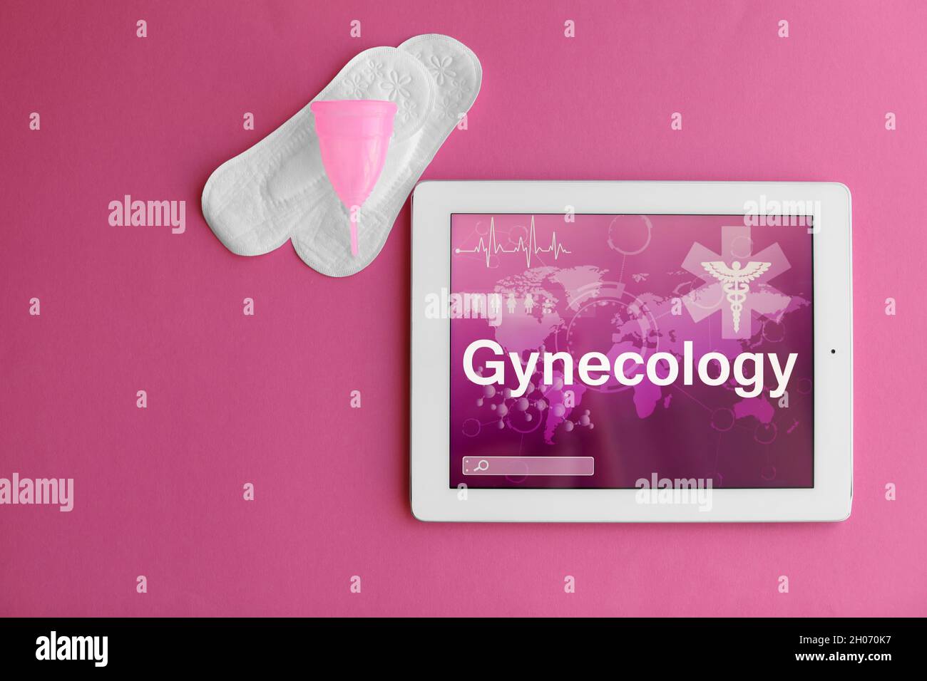 Flat lay composition with tablet and feminine hygiene items on color