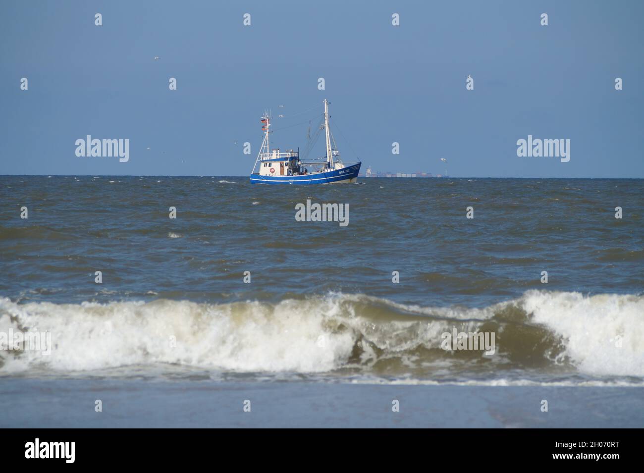 A blue fishing cutter in the North Sea in Germany Stock Photo