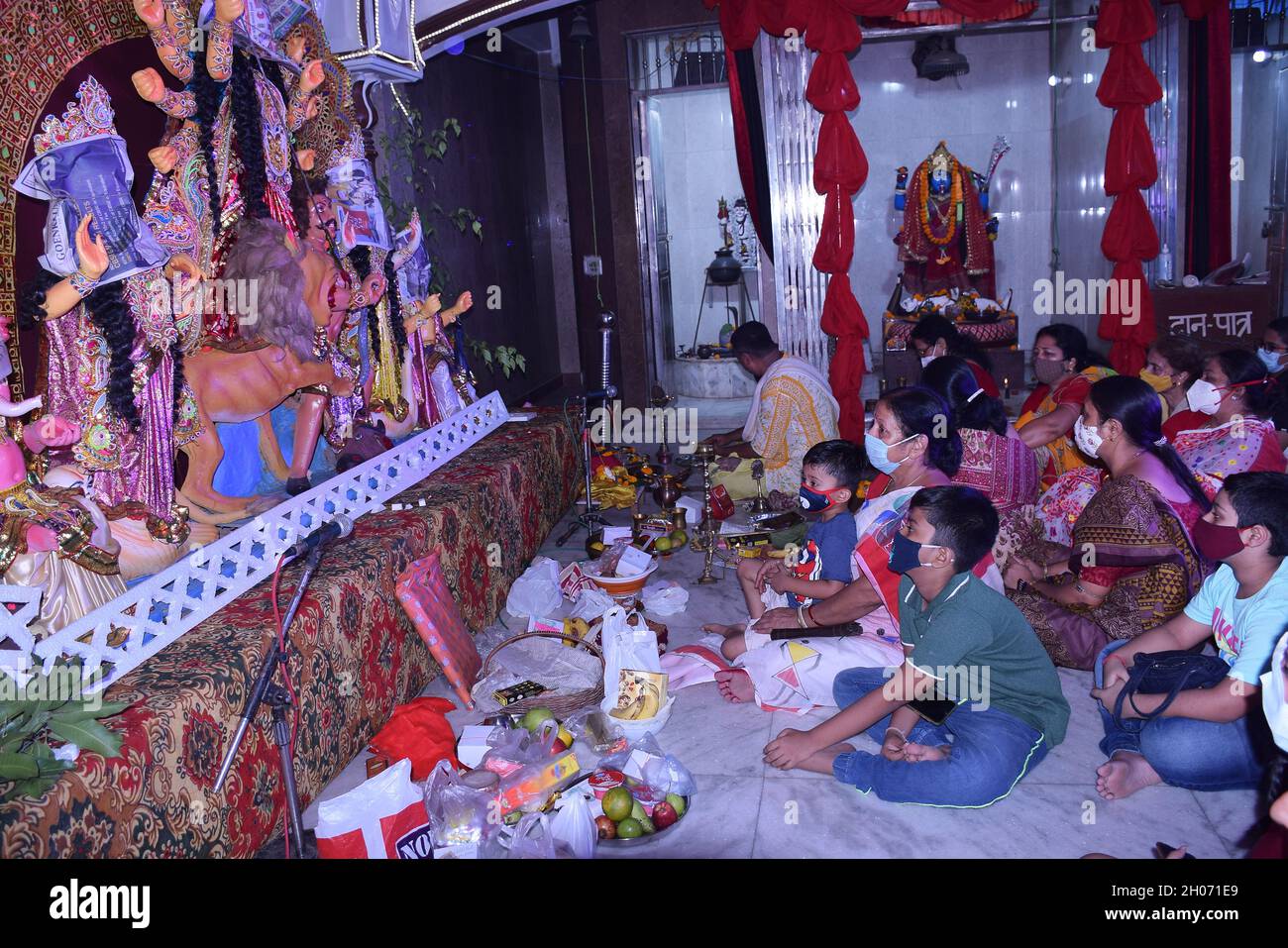 Devotees sitting in front of Covered Durga Idol face as the pooja is ...