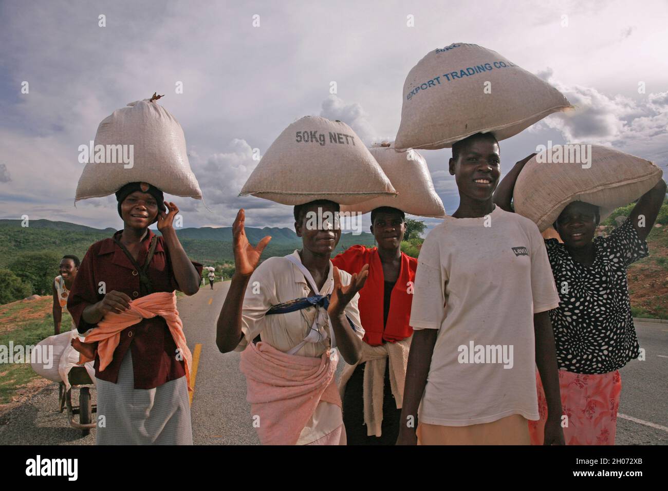 Zimbabwean women carrying food aid from the distribution centre