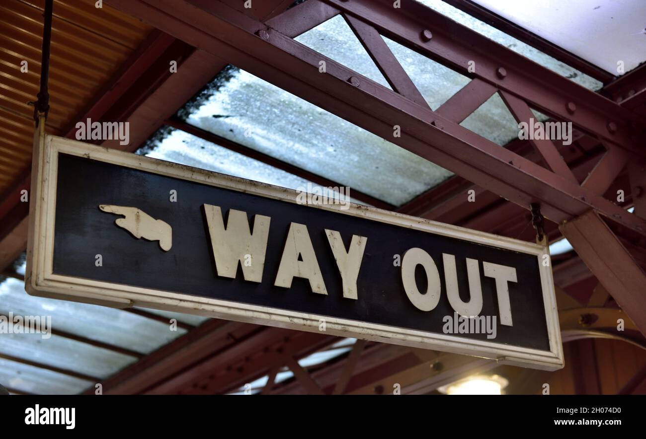 Old traditional “Way Out” sign with hand pointing Stock Photo