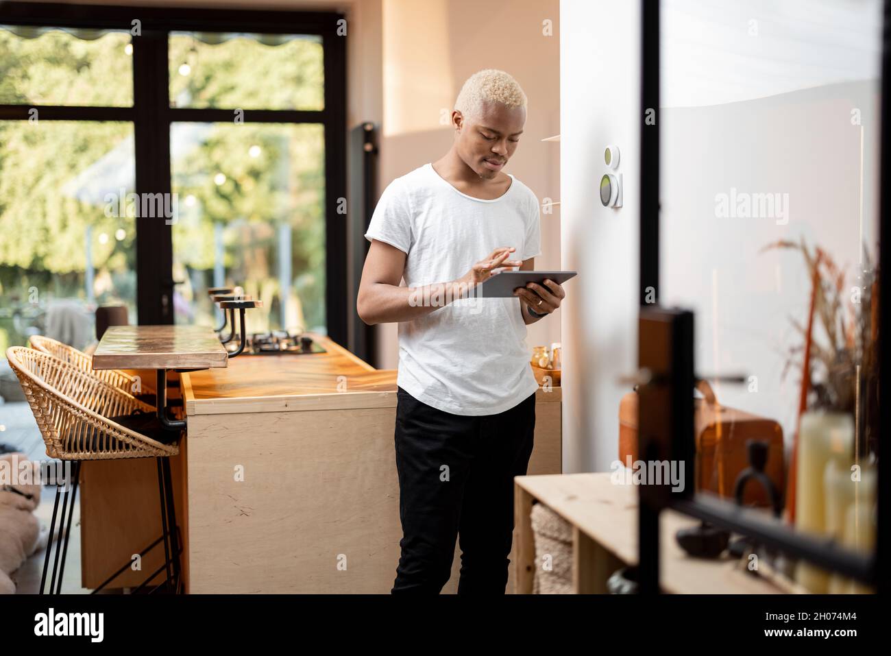 Latin man choosing temperature on thermostat Stock Photo
