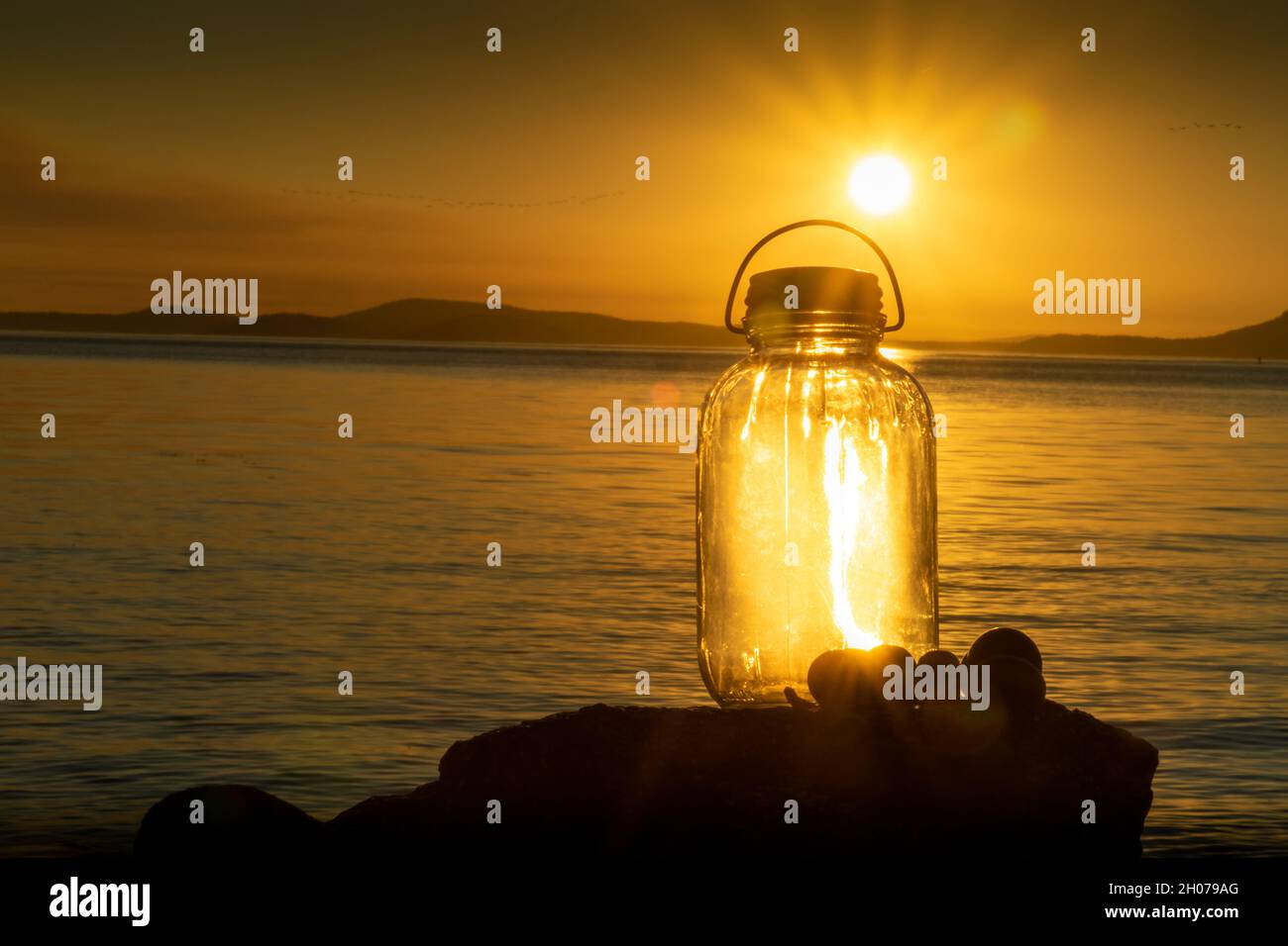 Vintage Glass Bottle lantern lit up from the sunset Stock Photo Alamy