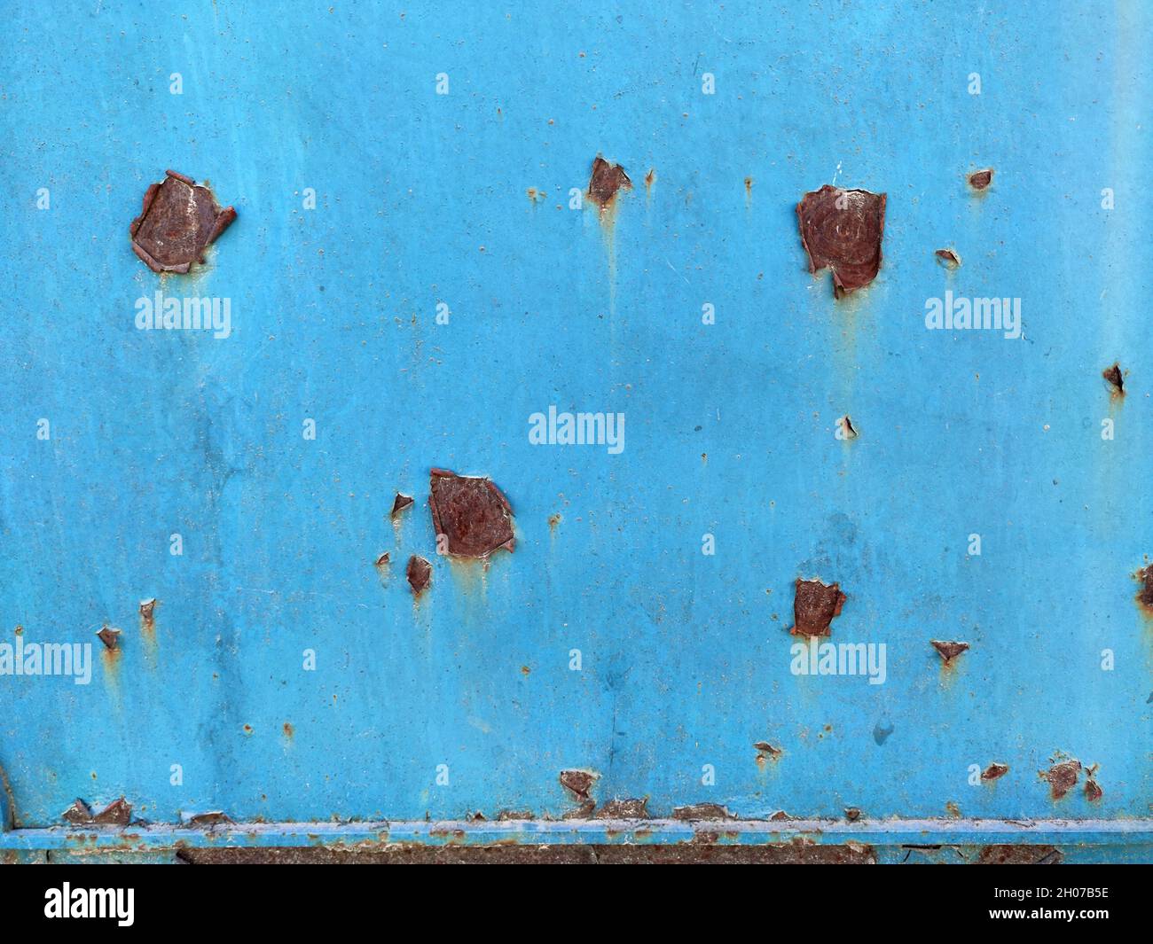 Rusty metal panel with cracked blue paint, corroded grunge metal background texture Stock Photo