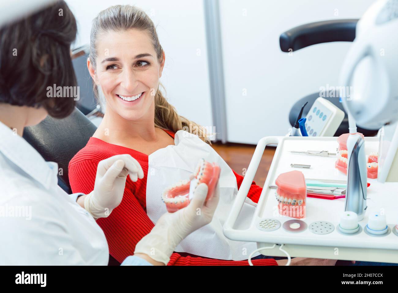 Dentist explaining to patient about dentures Stock Photo Alamy