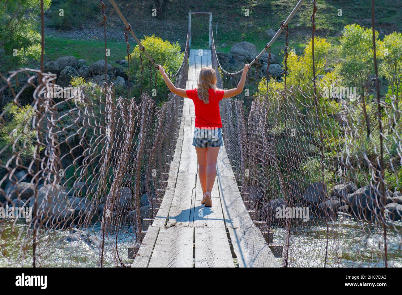 a girl walks along the underwater bridge in Georgia Stock Photo