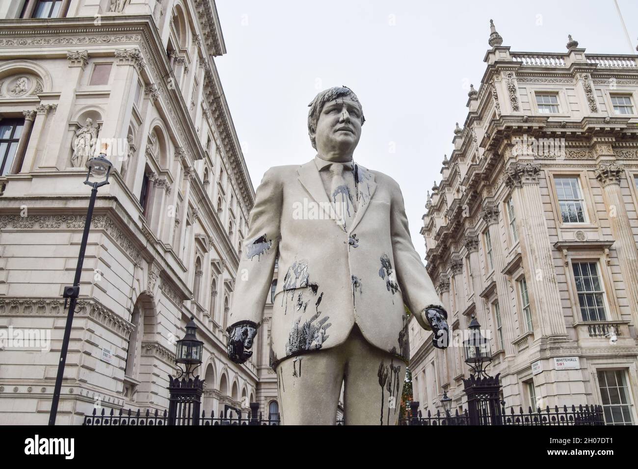 London, UK. 11th Oct, 2021. A statue of Boris Johnson splattered with fake oil is seen during the Stop Cambo protest.Greenpeace activists locked themselves to barrels and installed a large statue of Boris Johnson smeared in fake oil outside Downing Street, in protest against the Cambo oil field. (Photo by Vuk Valcic/SOPA Images/Sipa USA) Credit: Sipa USA/Alamy Live News Stock Photo