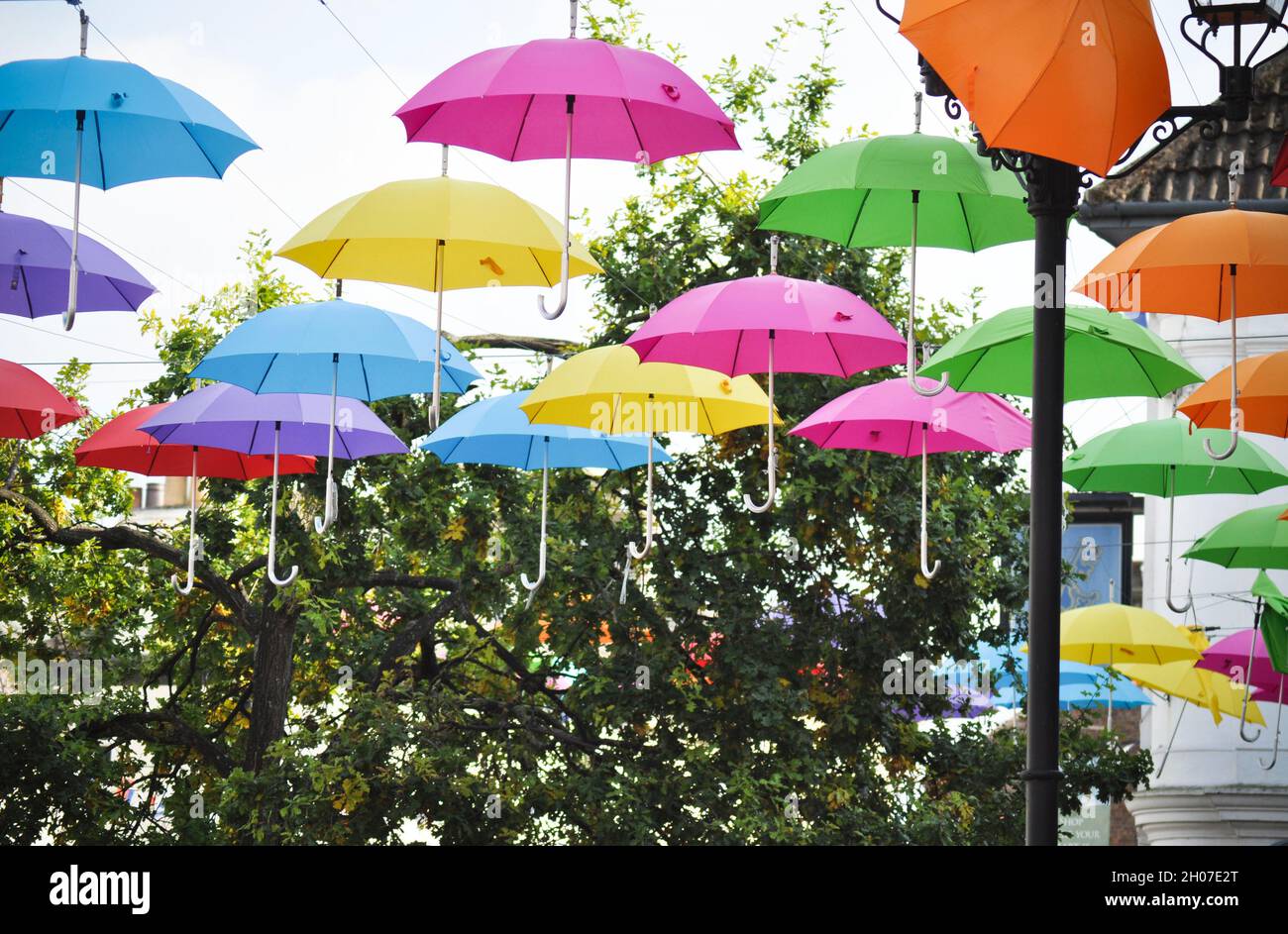 Colourful umbrellas hanging in Market Place, Driffield, England in the newly established food plaza. Stock Photo