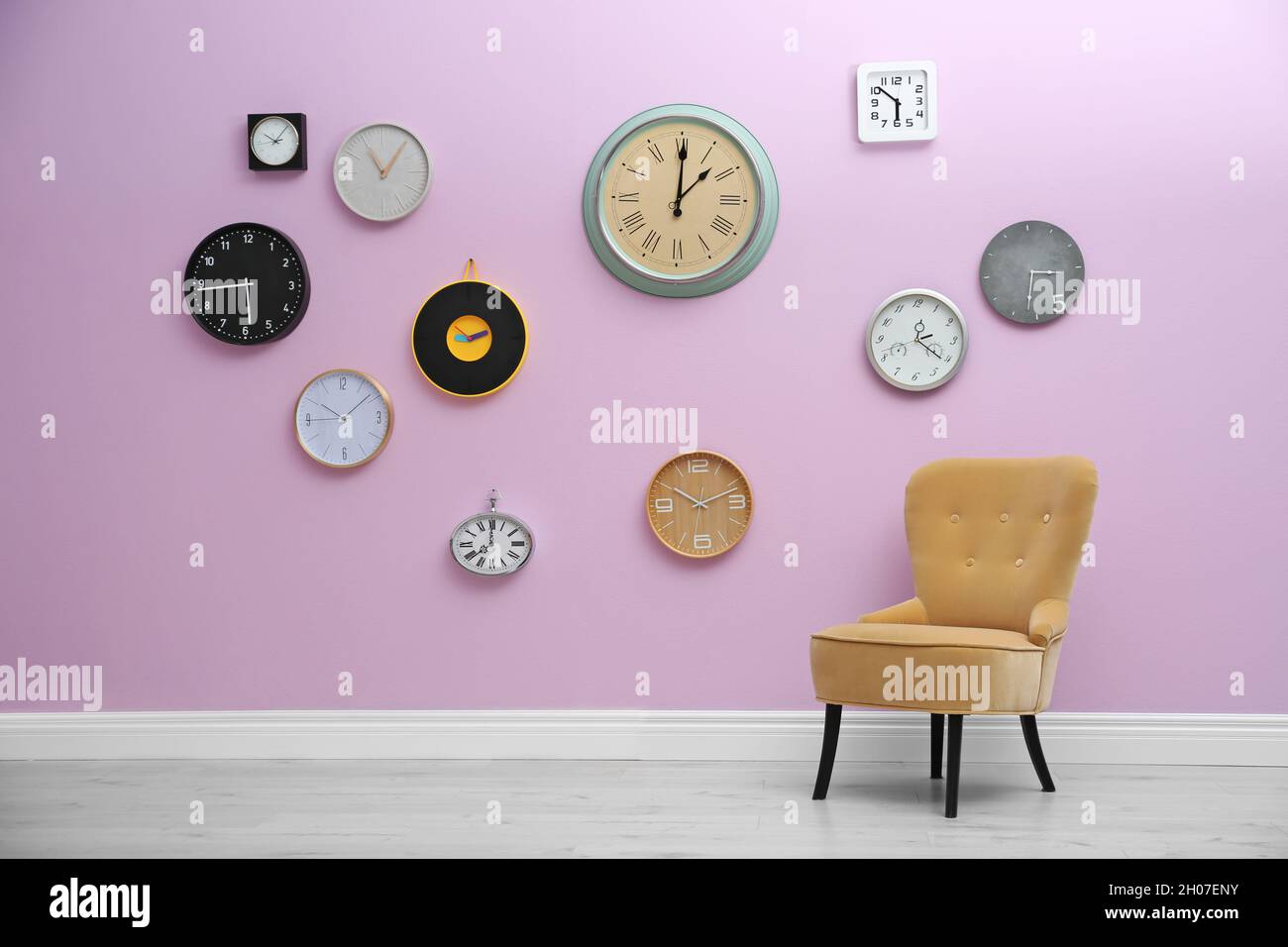 Room interior with many different clocks on wall. Time of day Stock Photo Alamy