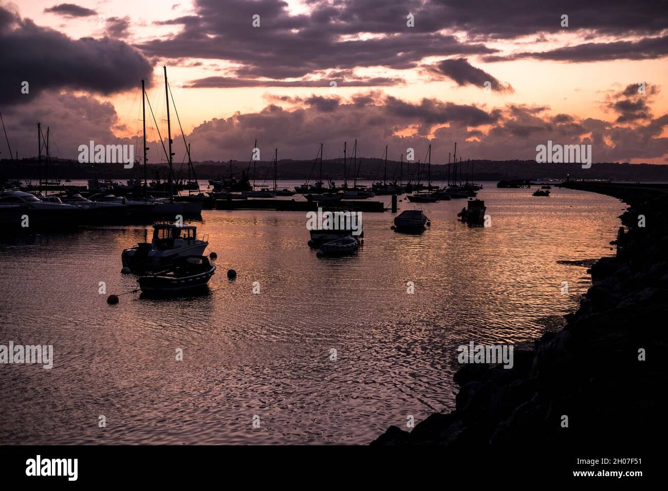 Boats in Brixham harbour, Devon, on a summer evening Stock Photo