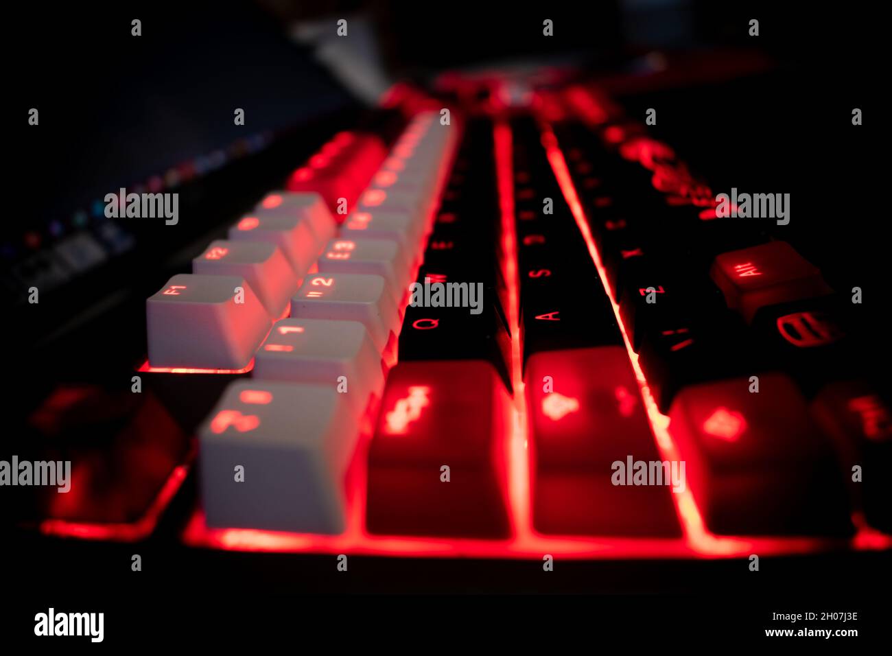Red Backlit Mechanical Keyboard with black, white, red keycaps at an angle  Stock Photo - Alamy