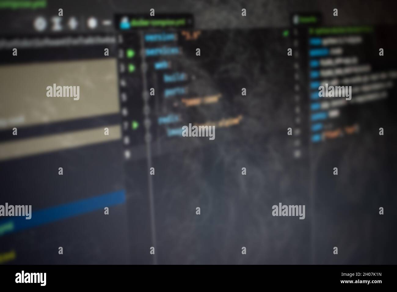 Docker compose Hello World code on screen blurry background image Stock Photo