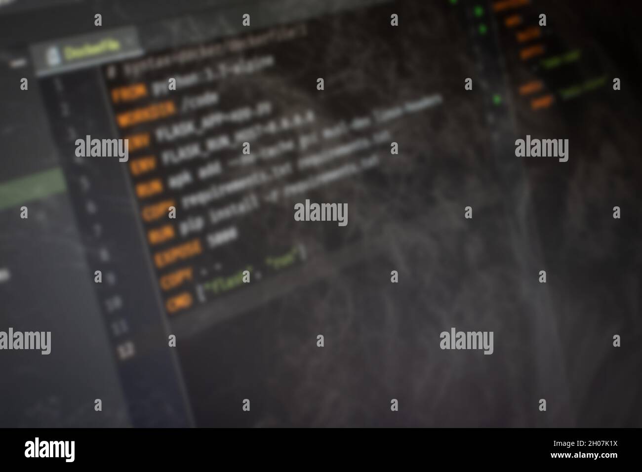Docker file Hello World code on screen blurry background image Stock ...