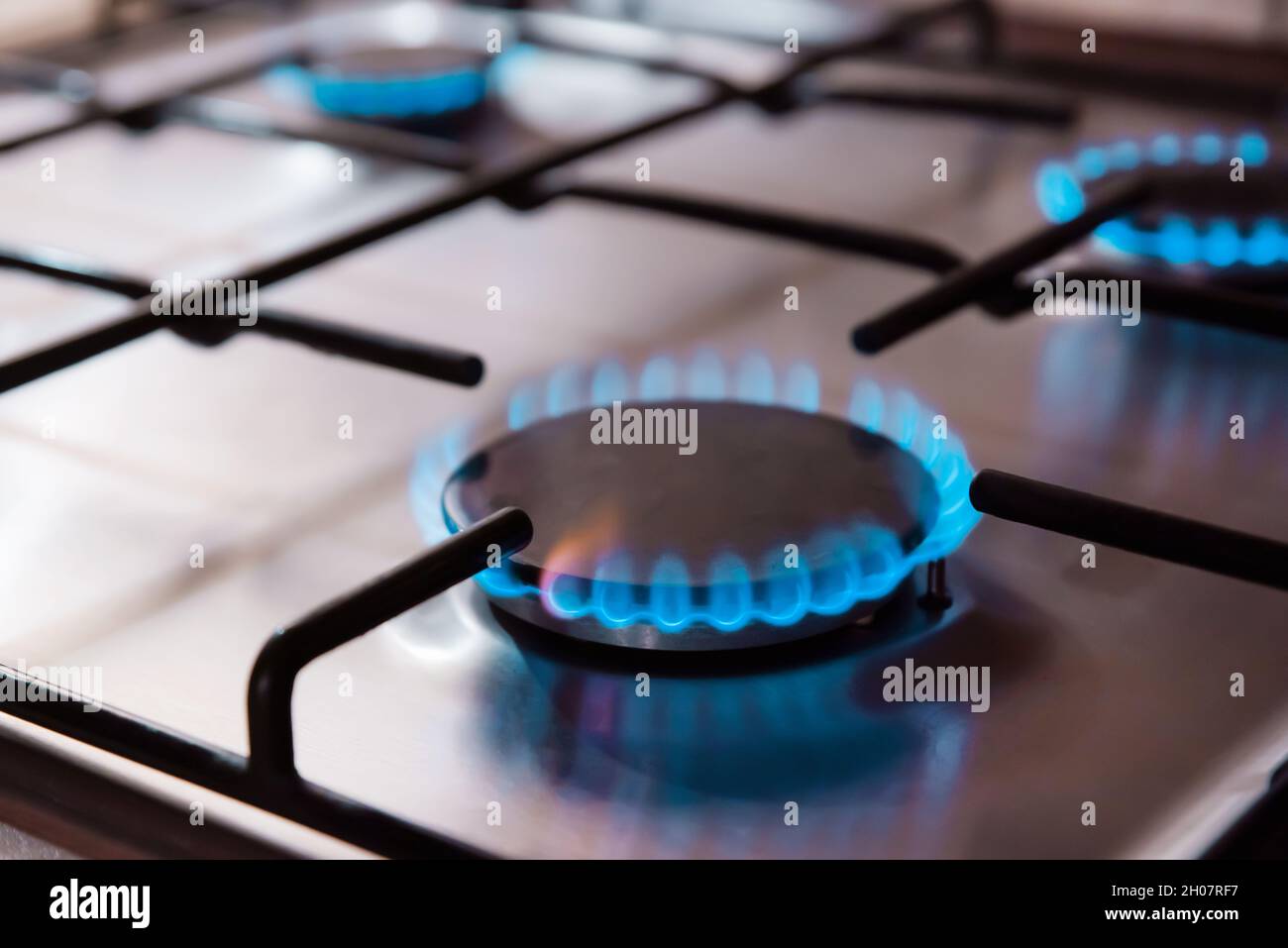 Gas cooker with burning flames of propane gas. Kitchen stove cook with