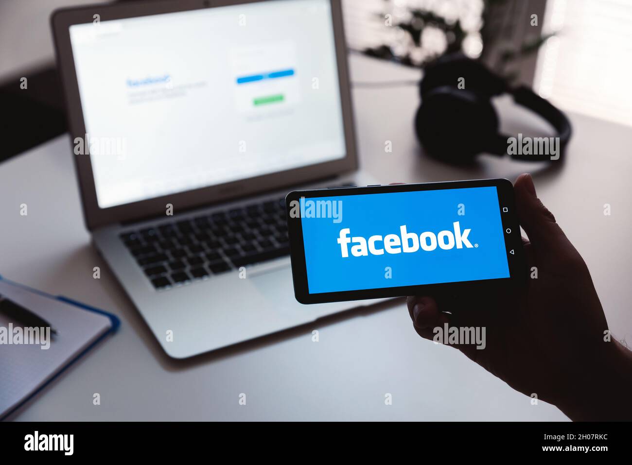 Wroclaw, Poland - JUN 17, 2021: Man using Facebook appication on Huawei P30 smart phone. Facebook is most popular social media service. Stock Photo