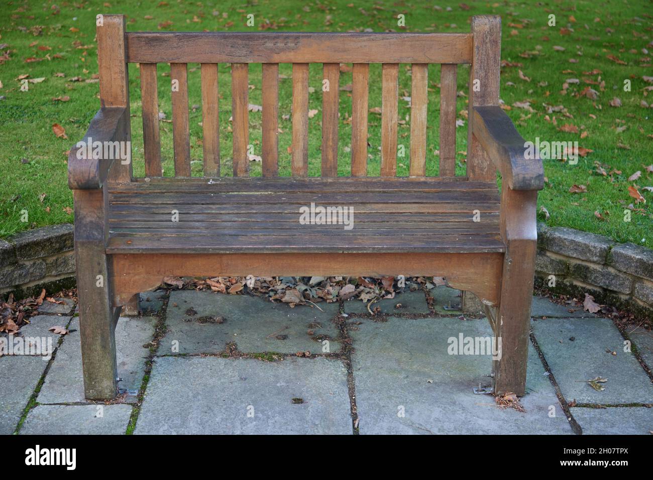 Exterior view of a wooden garden bench in October. Stock Photo