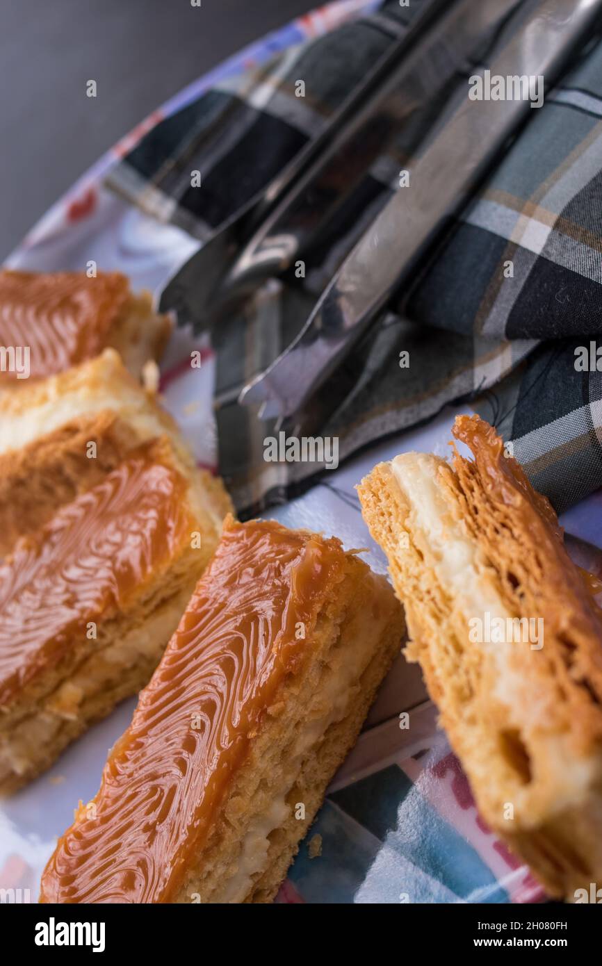 Some arequipe snacks with cream and some kitchen's clamps on a tray Stock Photo