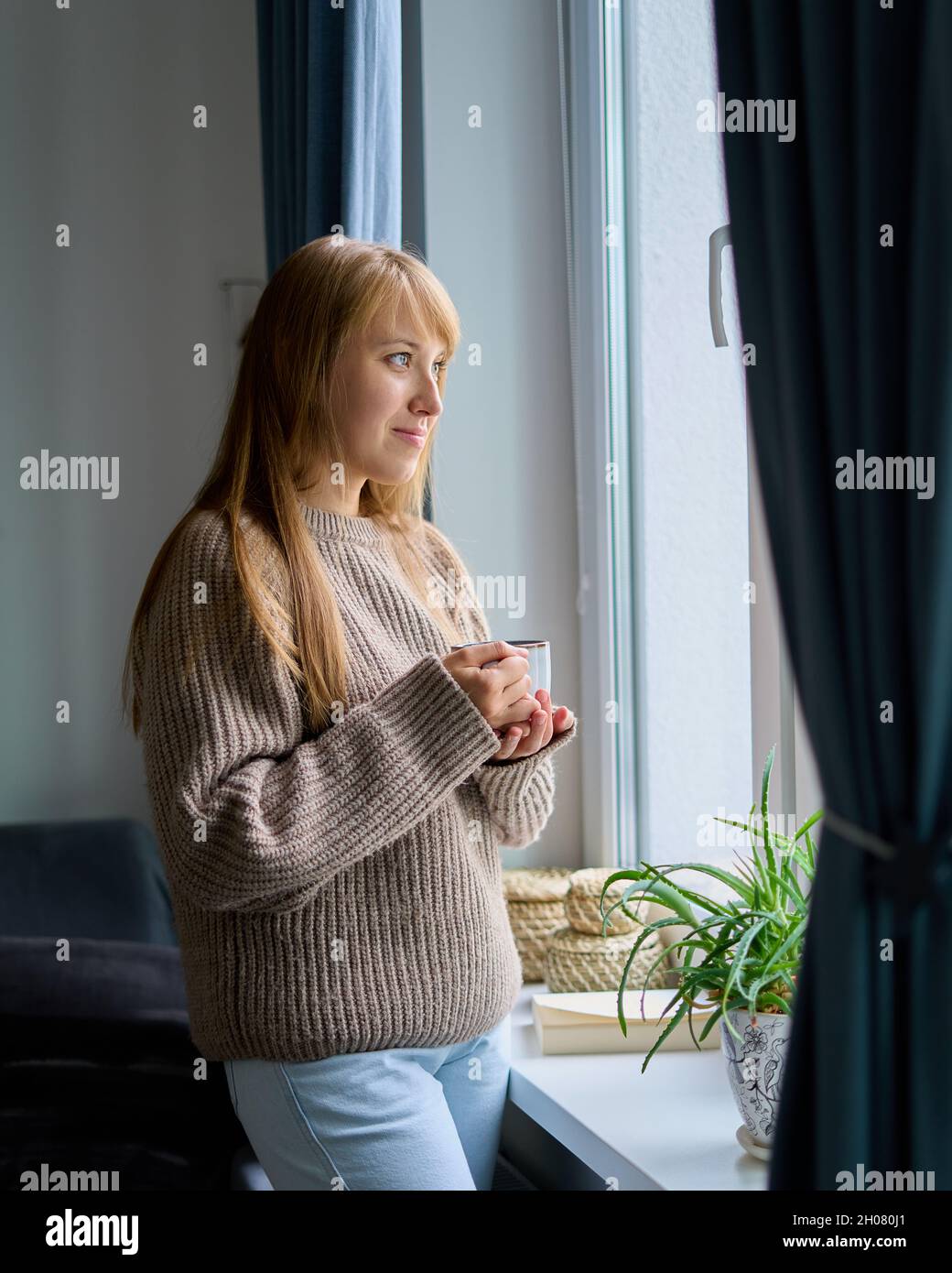 Slow living lifestyle. Mental health and wellbeing at home. Calm woman engaged in self reflection Stock Photo