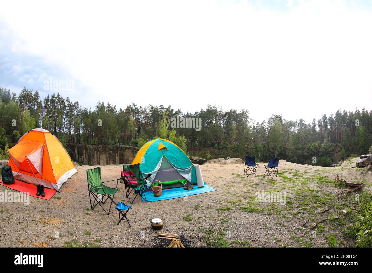 Camping tents and accessories in wilderness on summer day Stock Photo