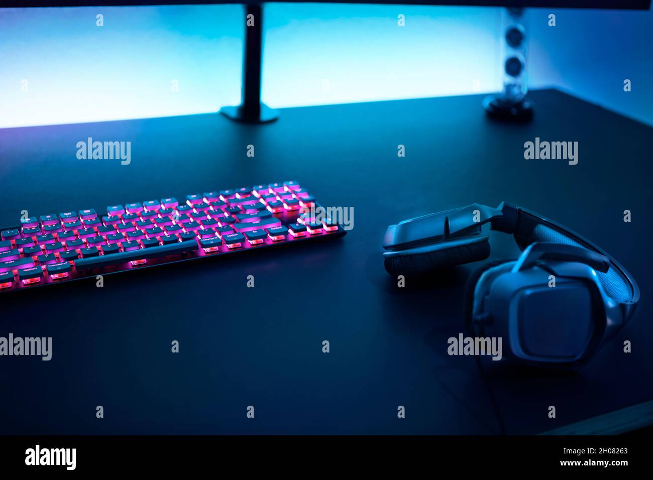 Gaming accessories on dark table. Keyboard with color backlit and