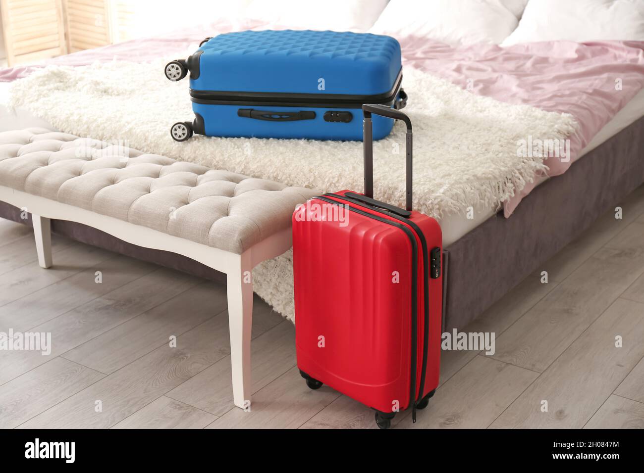 Travel suitcases in bedroom Stock Photo Alamy