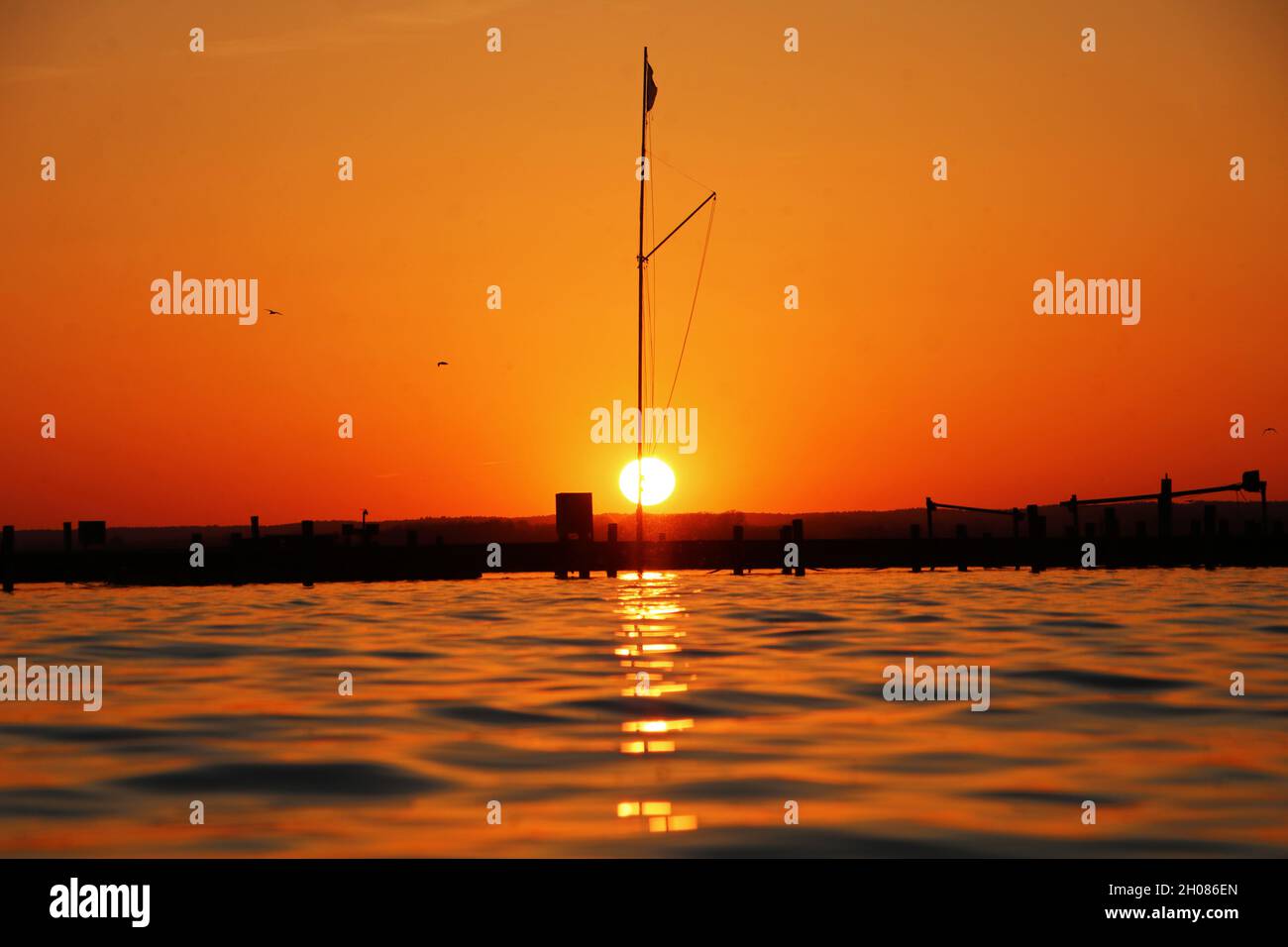 Beautiful view of the sunset sky reflecting on the sea Stock Photo - Alamy