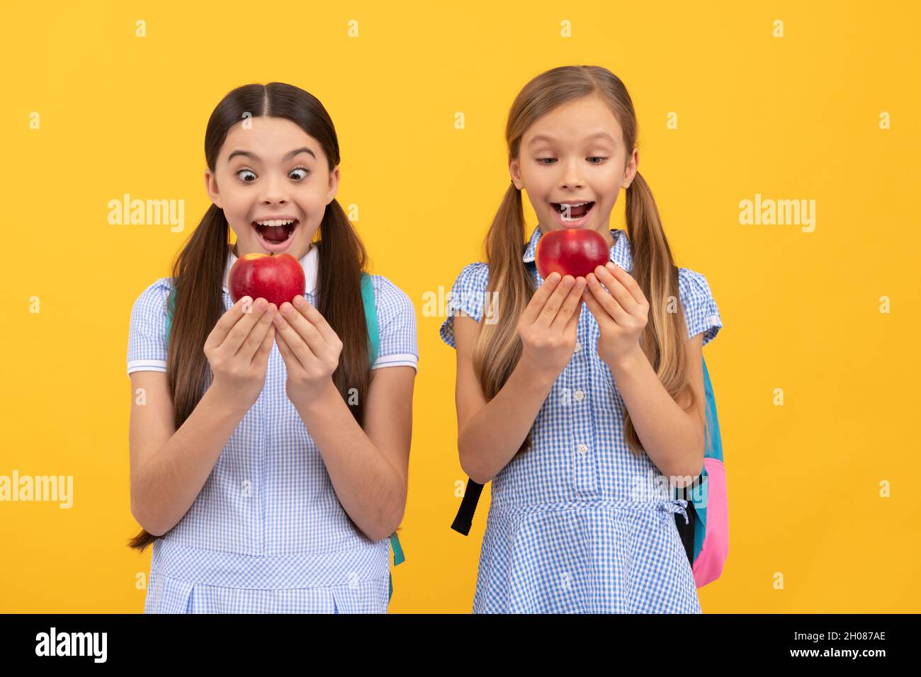 Nutrition for kids. Surprised children hold apples. School nutrition. Food education Stock Photo