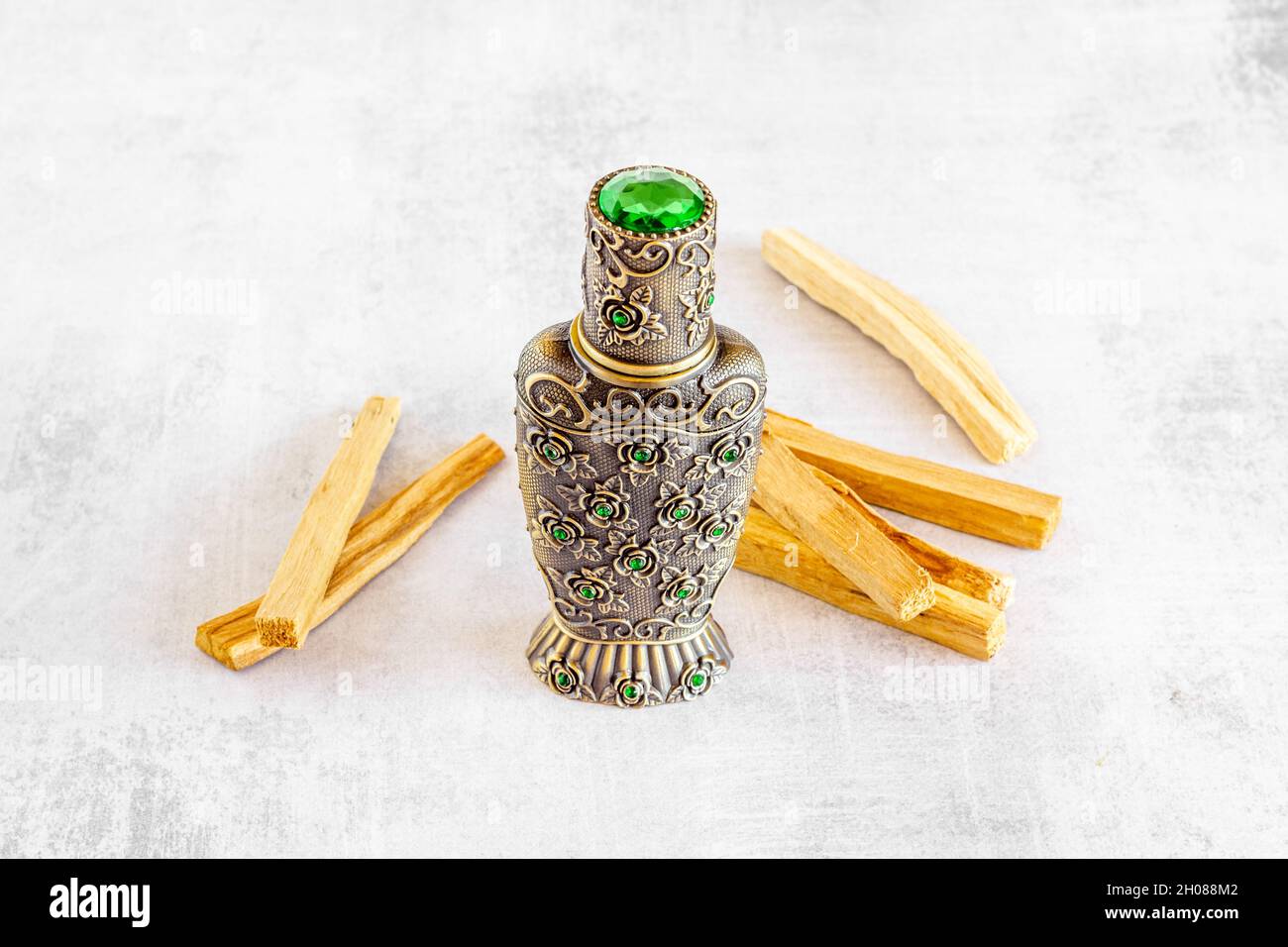 Agar wood tree oil perfume in silver bottle with sticks of tree Stock Photo  - Alamy
