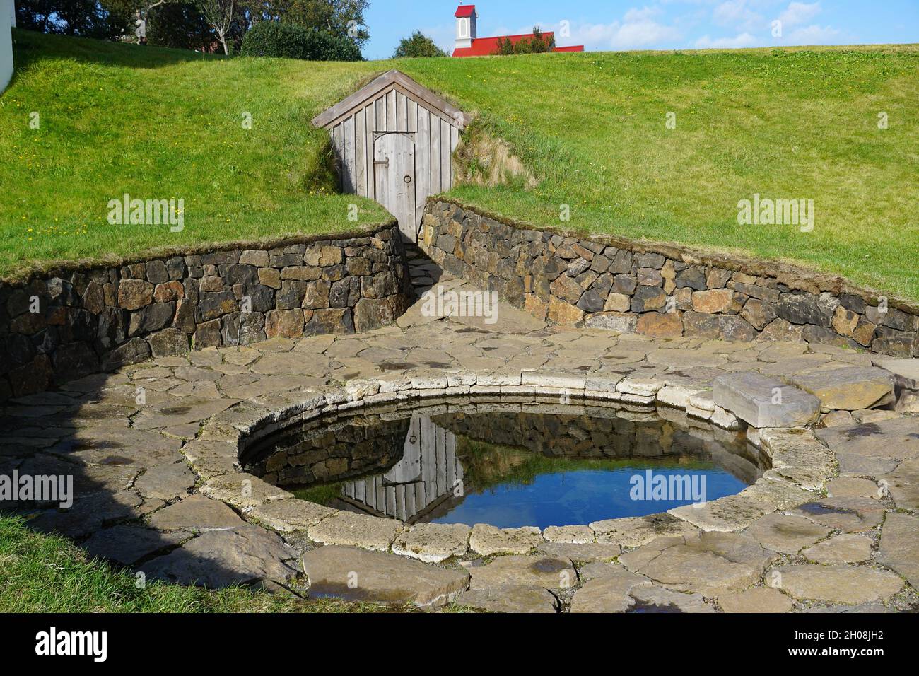 Reykholt, Iceland: Snorralaug, the warm outdoor bathing pool of Snorri Sturluson and one of the first archaeological remains to be listed in Iceland. Stock Photo